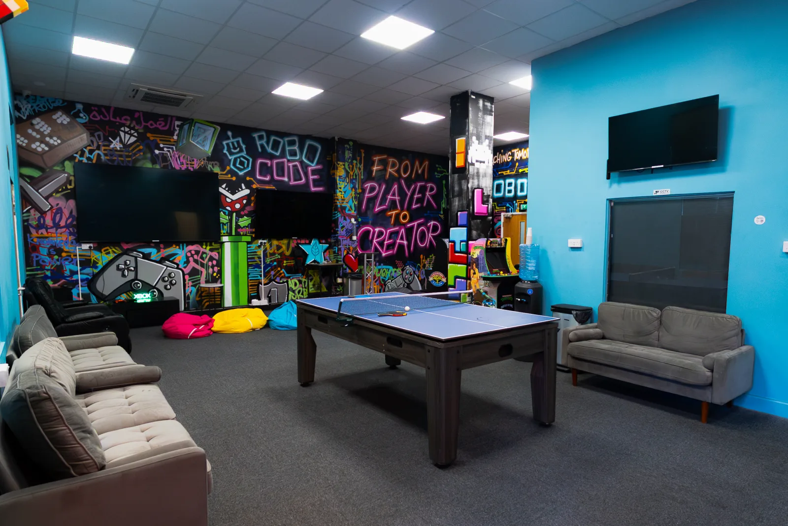 The Robocode games room, with a table tennis table and graffiti wall