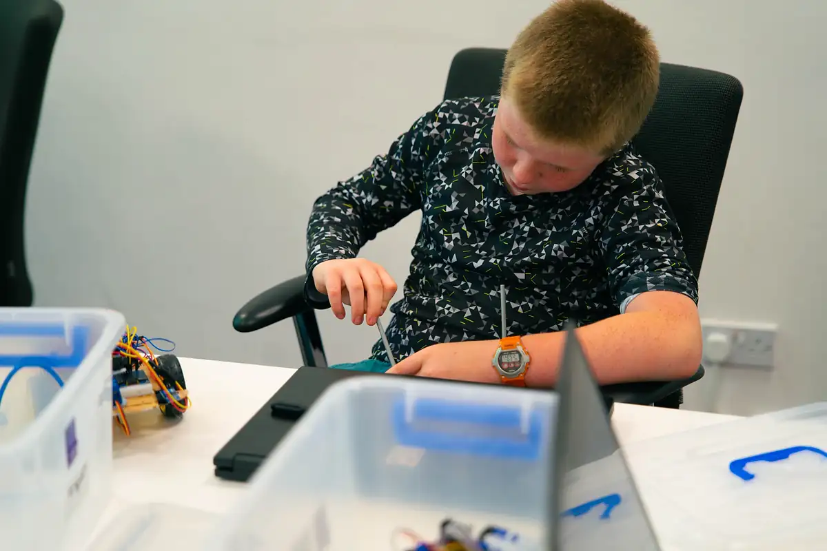 Close-up of a student wiring a circuit